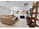 Relaxing living room with a cozy couch, TV, and decorations at 3420 Middlebrook Pl, Harmony, FL 34773