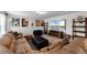Cozy living room with sectional sofa, television and movie themed decor at 3420 Middlebrook Pl, Harmony, FL 34773