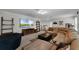 Spacious living room featuring a sectional sofa, television, and media console at 3420 Middlebrook Pl, Harmony, FL 34773