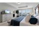 Relaxing main bedroom featuring a king bed, sitting area, and serene views at 3420 Middlebrook Pl, Harmony, FL 34773
