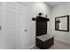 Convenient mudroom featuring a bench with storage, coat hooks, and a stylish mirror at 3420 Middlebrook Pl, Harmony, FL 34773