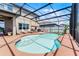 Luxurious pool with screened-in lanai, lounge chairs, dining area and well-manicured yard at 3420 Middlebrook Pl, Harmony, FL 34773