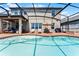 Beautiful outdoor pool area with a covered patio, comfortable seating, and scenic views at 3420 Middlebrook Pl, Harmony, FL 34773