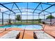 Resort-style pool area featuring comfortable lounge chairs, hammock, and tranquil water views at 3420 Middlebrook Pl, Harmony, FL 34773