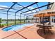 Inviting screened-in pool area with lounge chairs, dining table, and lush landscaping at 3420 Middlebrook Pl, Harmony, FL 34773