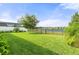 Expansive backyard with lush green grass, fenced-in yard, and lake view at 3424 Middlebrook Pl, Harmony, FL 34773