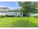 A well-maintained backyard featuring lush green grass, tree, and a view of the rear of the home at 3424 Middlebrook Pl, Harmony, FL 34773
