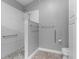 This is a walk-in shower featuring white subway tile with safety bars and gray pebble floor at 3424 Middlebrook Pl, Harmony, FL 34773