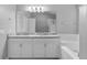 This is a full bathroom featuring a double sink vanity, soaking tub and walk-in shower at 3424 Middlebrook Pl, Harmony, FL 34773