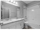 Bright bathroom with a double sink vanity, granite counters, and shower over tub at 3424 Middlebrook Pl, Harmony, FL 34773