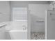 This is a beautiful soaking tub with an adjacent shower and decorative pebble tile floor at 3424 Middlebrook Pl, Harmony, FL 34773