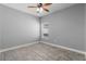 Bright bedroom with modern ceiling fan and wood-look tile flooring at 3424 Middlebrook Pl, Harmony, FL 34773