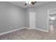 A spacious bedroom with wood-look tile flooring and neutral gray walls at 3424 Middlebrook Pl, Harmony, FL 34773