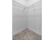 Walk-in closet with wire shelving and durable tile flooring at 3424 Middlebrook Pl, Harmony, FL 34773