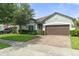 Charming single-story home with brick driveway, manicured lawn, and mature landscaping at 3424 Middlebrook Pl, Harmony, FL 34773