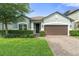 Charming single-story home featuring manicured lawn and a two-car garage at 3424 Middlebrook Pl, Harmony, FL 34773