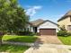 Charming single-Gathering home with a well-manicured lawn and a brick paver driveway at 3424 Middlebrook Pl, Harmony, FL 34773