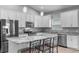 Bright kitchen featuring white cabinets, stainless steel appliances, and granite countertops at 3424 Middlebrook Pl, Harmony, FL 34773