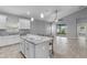 Modern kitchen featuring a granite island, white cabinets, and stainless steel appliances at 3424 Middlebrook Pl, Harmony, FL 34773
