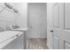 This is a well-lit laundry room with front-loading washer, dryer, and overhead storage at 3424 Middlebrook Pl, Harmony, FL 34773