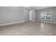 Bright living room featuring tile floors, neutral walls, and a front door entrance at 3424 Middlebrook Pl, Harmony, FL 34773