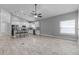 Spacious living area adjacent to a bright and modern kitchen with seating at 3424 Middlebrook Pl, Harmony, FL 34773