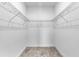 This is a walk-in closet with wire shelving and wood-style floors at 3424 Middlebrook Pl, Harmony, FL 34773