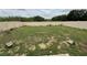 Expansive backyard featuring patchy grass and a white vinyl fence at 3476 Yarian Dr, Haines City, FL 33844