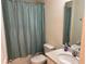 Bathroom with shower, square-patterned shower curtain, and neutral vanity at 3476 Yarian Dr, Haines City, FL 33844
