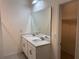 Bright bathroom featuring a double vanity with quartz countertop and ample storage at 3476 Yarian Dr, Haines City, FL 33844