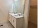 Bright bathroom featuring a double vanity with quartz countertop and ample storage at 3476 Yarian Dr, Haines City, FL 33844