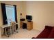 Bright room with a desk, wood-look floors, and natural light from a window at 3476 Yarian Dr, Haines City, FL 33844