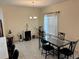 Cozy dining room with glass-top table, plants, and natural lighting at 3476 Yarian Dr, Haines City, FL 33844