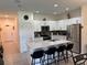 Modern kitchen features white cabinets, stainless appliances, island with breakfast bar at 3476 Yarian Dr, Haines City, FL 33844
