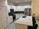Bright kitchen with white cabinets, stainless steel appliances, and a large quartz island at 3476 Yarian Dr, Haines City, FL 33844