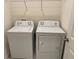 Functional laundry area with standard-size white washer and dryer units at 3476 Yarian Dr, Haines City, FL 33844