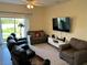 Living room featuring sofas, television, and decorative accents at 3476 Yarian Dr, Haines City, FL 33844