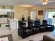 Open concept living space featuring theater seating, dining area, and kitchen at 3476 Yarian Dr, Haines City, FL 33844