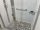 Modern shower featuring pebble flooring, grab bar, and sliding glass door at 3476 Yarian Dr, Haines City, FL 33844