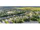 An aerial view showcasing the layout of a neighborhood featuring tree-lined streets and well-maintained homes and lawns at 3606 Solana Cir, Clermont, FL 34711