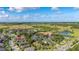 An aerial view showcasing the property's location within a community with lush landscaping and recreational amenities including a pool at 3606 Solana Cir, Clermont, FL 34711