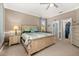 Spacious bedroom with a neutral color scheme, ceiling fan, and ample closet space at 3606 Solana Cir, Clermont, FL 34711