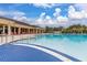 A large community pool with blue tile sits next to lounge chairs for community members at 3606 Solana Cir, Clermont, FL 34711