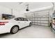 Spacious two-car garage featuring an automatic door and ample storage space with a parked car at 3606 Solana Cir, Clermont, FL 34711