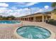 Inviting community hot tub next to a large pool and deck with lounge chairs, perfect for relaxation and socializing at 3606 Solana Cir, Clermont, FL 34711