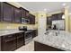 Stylish kitchen with stainless steel appliances, granite countertops, and plenty of cabinet space at 3606 Solana Cir, Clermont, FL 34711