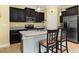 Modern kitchen with dark cabinets, stainless steel appliances, and granite countertops at 3606 Solana Cir, Clermont, FL 34711