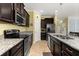 Well-equipped kitchen featuring granite countertops, stainless steel appliances, and ample cabinet space at 3606 Solana Cir, Clermont, FL 34711