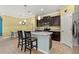 Eat-in kitchen with stainless appliances, granite counters, dark cabinets and bar stool seating at 3606 Solana Cir, Clermont, FL 34711