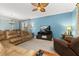 Bright living room showcasing a large sofa, entertainment center, and stylish decor at 3606 Solana Cir, Clermont, FL 34711